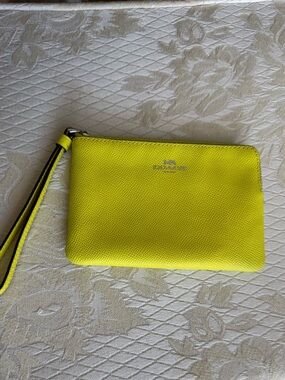 Coach corner zip wristlet in bright yellow leather